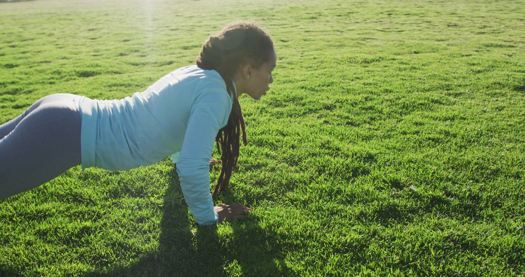 Young Woman Exercising Outdoors in Yoga Pose on Green Lawn - Free Images, Stock Photos and Pictures on Pikwizard.com