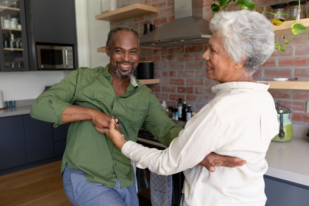 Senior couple dancing together at home - Free Images, Stock Photos and Pictures on Pikwizard.com