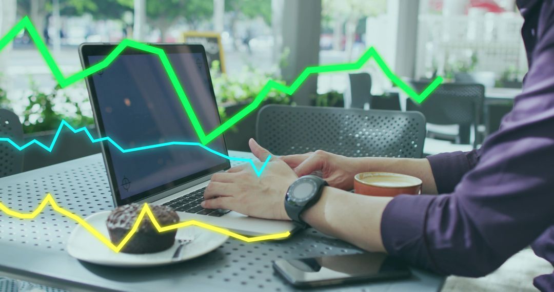 Businessman Analyzing Data with Laptop in Coffee Shop Setting