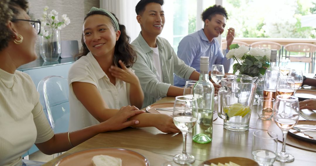 Friends Enjoying Conversation and Laughter at Elegant Dinner Party