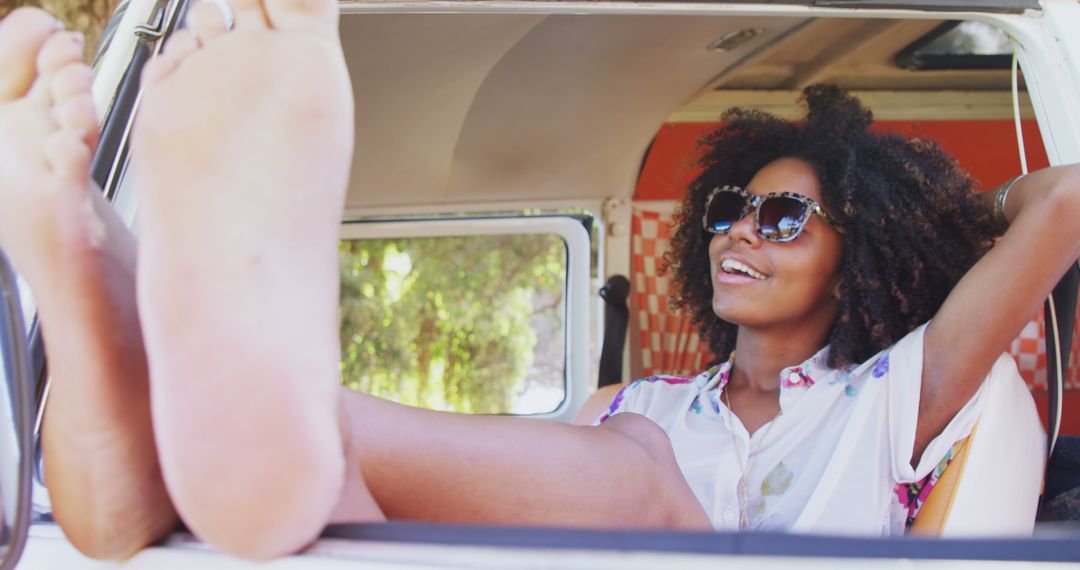 A joyful African American woman embodies summer freedom in a vintage van. - Free Images, Stock Photos and Pictures on Pikwizard.com