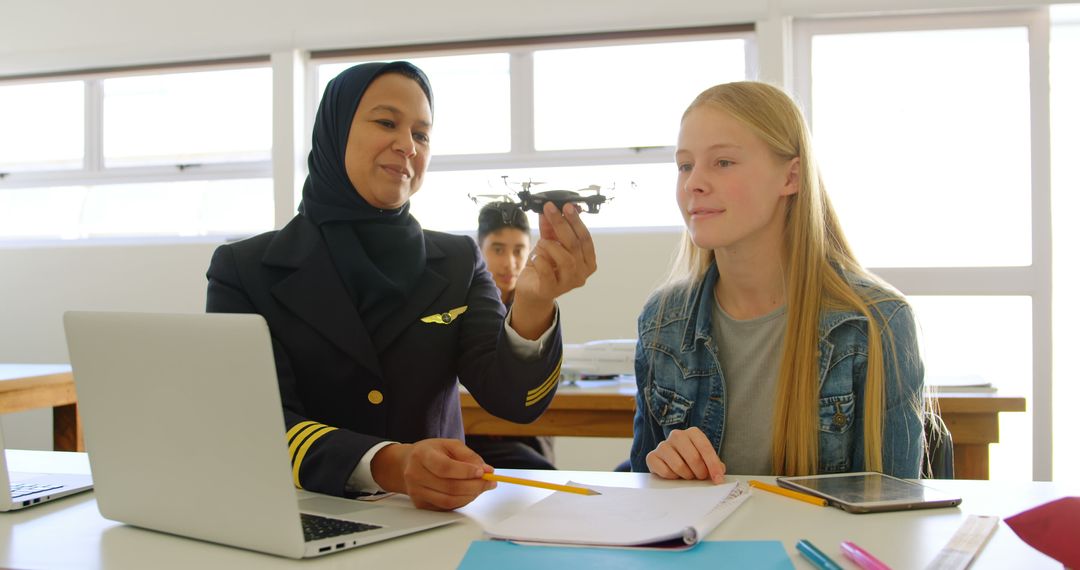 Female Pilot Instructor Teaching Aviation to Young Student in Classroom - Free Images, Stock Photos and Pictures on Pikwizard.com