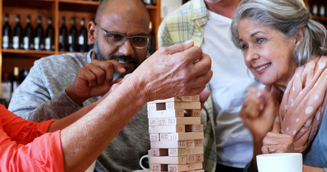 Middle-Aged Adults Enjoying Game of Jenga Together
