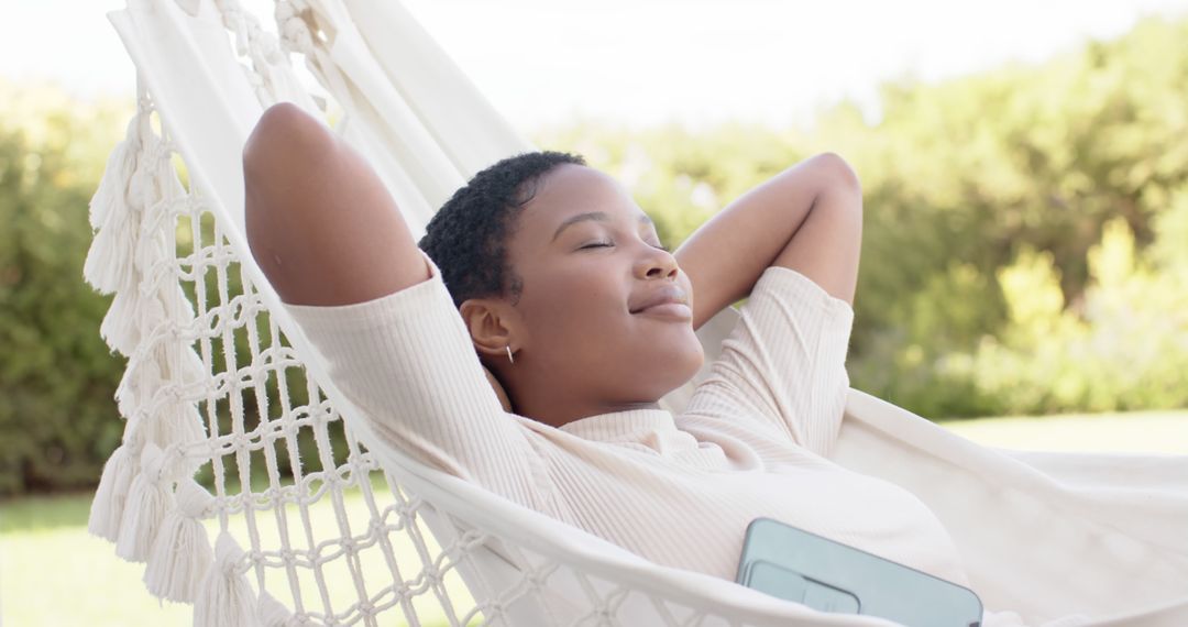 Young Woman Relaxing on Hammock in Sunny Garden - Free Images, Stock Photos and Pictures on Pikwizard.com