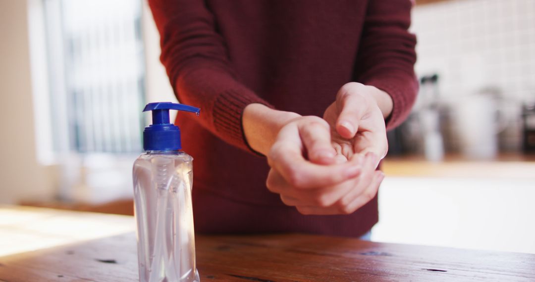 Close-up of Person Using Hand Sanitizer in Kitchen - Free Images, Stock Photos and Pictures on Pikwizard.com