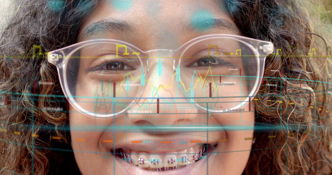 Smiling young student studying digital charts through glasses with colorful braces overlay