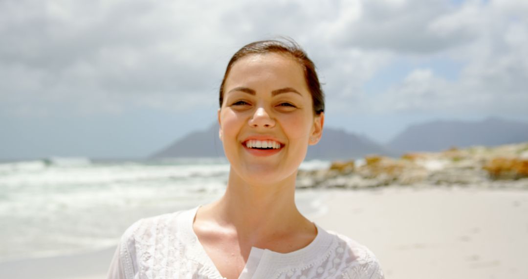 Cheerful Caucasian Woman in White Dress Relaxing on Sandy Beach at Sunrise - Free Images, Stock Photos and Pictures on Pikwizard.com