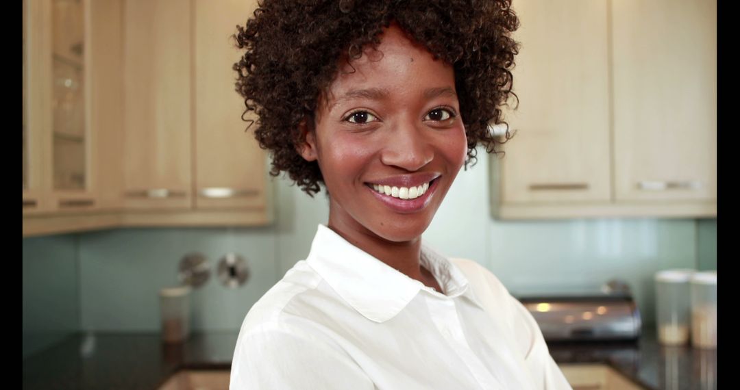 Smiling Woman in Modern Kitchen Wearing White Shirt - Free Images, Stock Photos and Pictures on Pikwizard.com