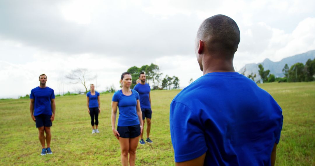 Team Fitness Training Session in Open Field with Diverse Group