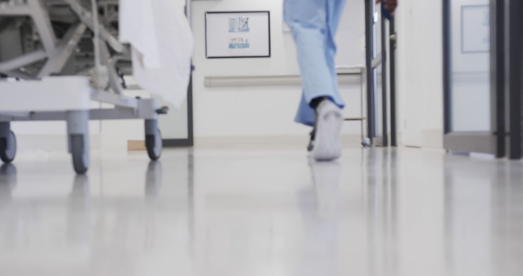 Healthcare Professional Walking in Modern Hospital Corridor - Free Images, Stock Photos and Pictures on Pikwizard.com