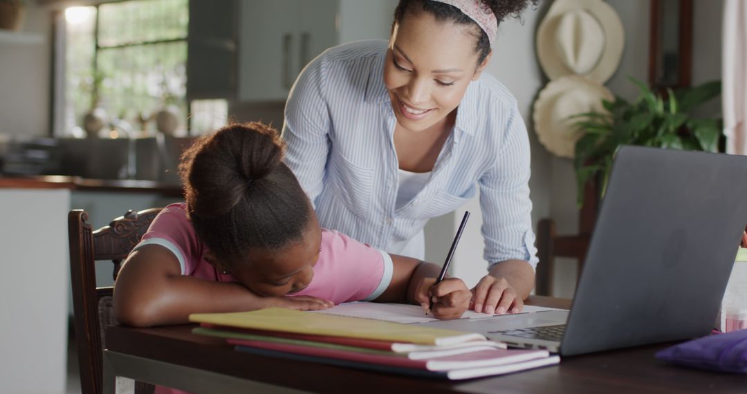 Mother Helping Daughter with Homework at Dining Table - Free Images, Stock Photos and Pictures on Pikwizard.com