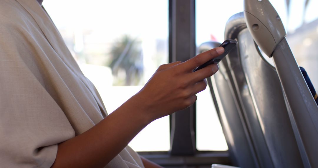 Person holding smartphone while sitting on public bus - Free Images, Stock Photos and Pictures on Pikwizard.com