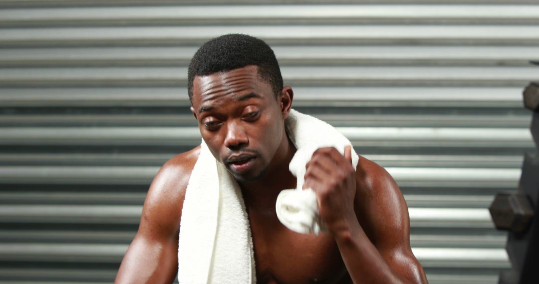 Man Wiping Sweat Off After Intense Workout At Gym - Free Images, Stock Photos and Pictures on Pikwizard.com