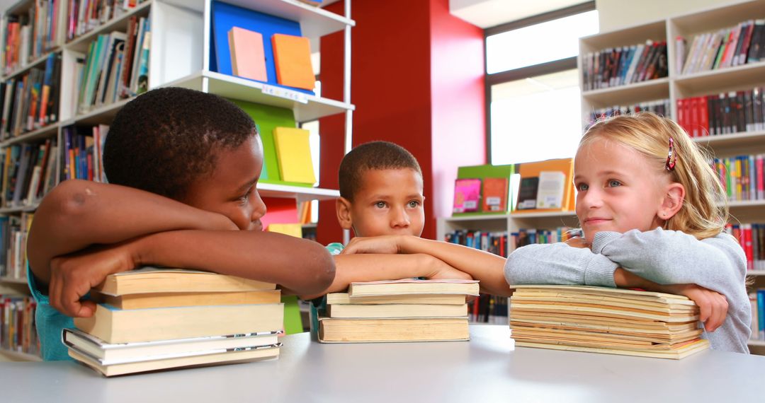 Schoolchildren Relaxing with Books in Colorful Library - Free Images, Stock Photos and Pictures on Pikwizard.com