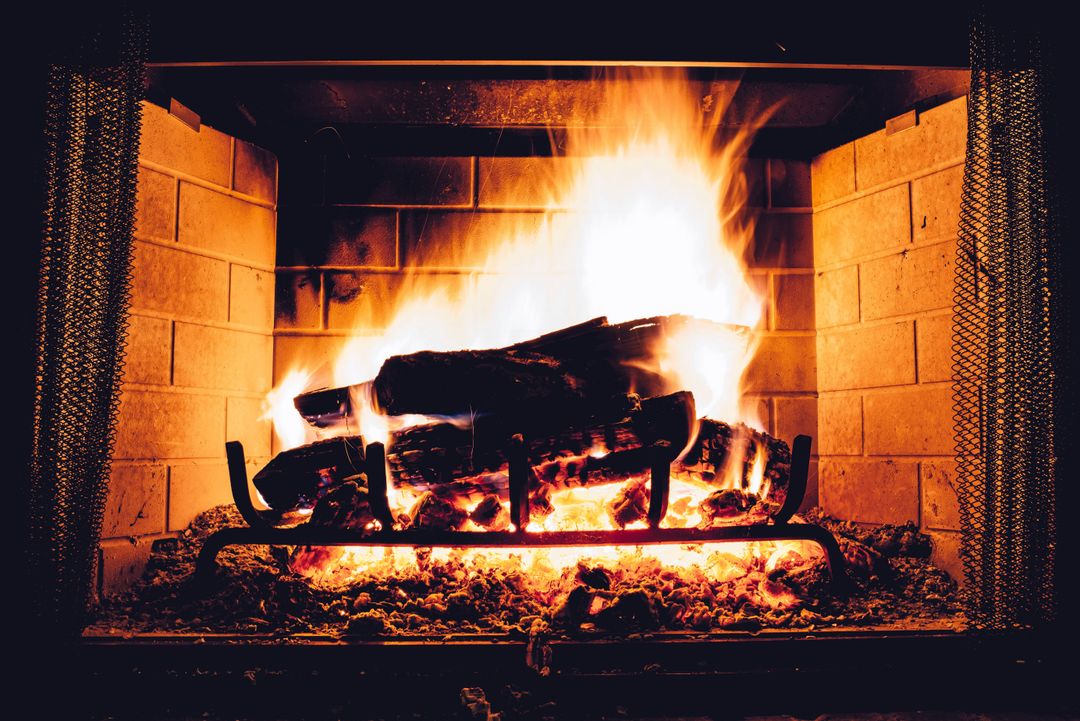 Brick Fireplace with Burning Logs and Glowing Flames