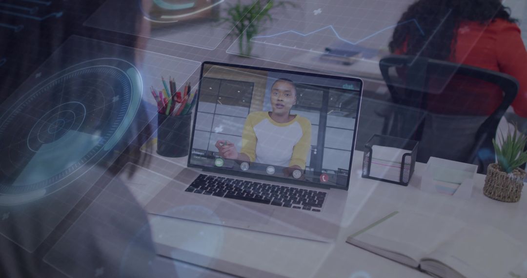 Remote team collaborating via laptop video call with futuristic HUD overlay in office