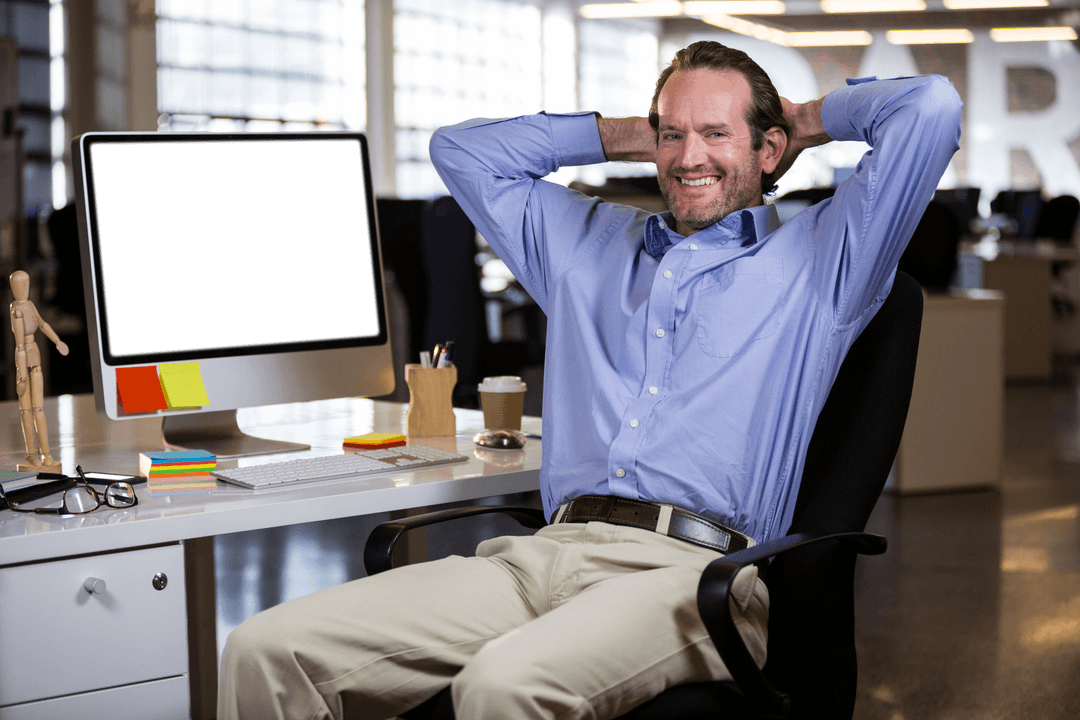 Satisfied Businessman Relaxing at Transparent Workstation in Modern Office