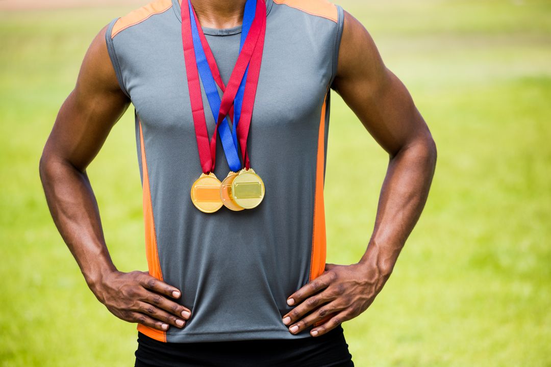 Athlete posing with gold medals around his neck - Free Images, Stock Photos and Pictures on Pikwizard.com