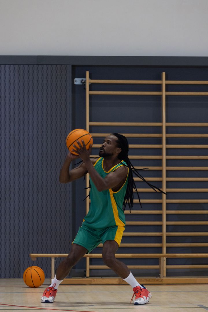 Athlete Practicing Basketball Skills on Indoor Court