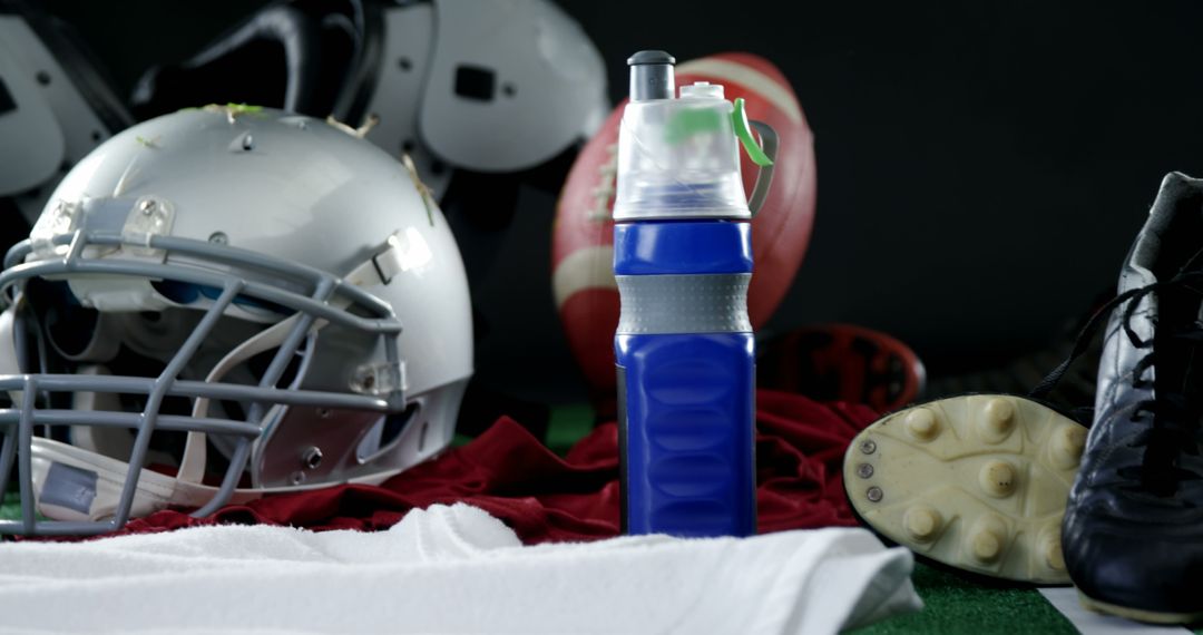 Football Equipment and Hydration Bottle on Gym Floor - Free Images, Stock Photos and Pictures on Pikwizard.com