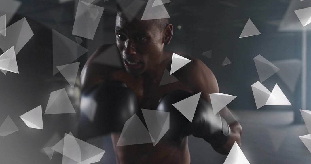 Moody Low-Light Male Boxer Training with Black Gloves and Triangular Graphic Overlays