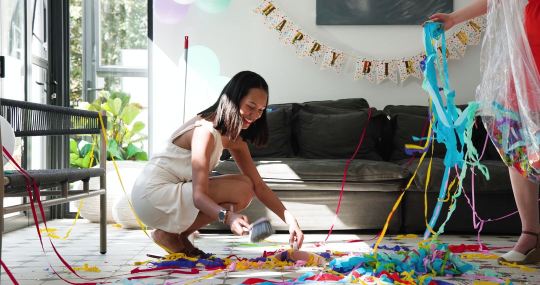 Friends Cleaning Up After Birthday Party with Streamers