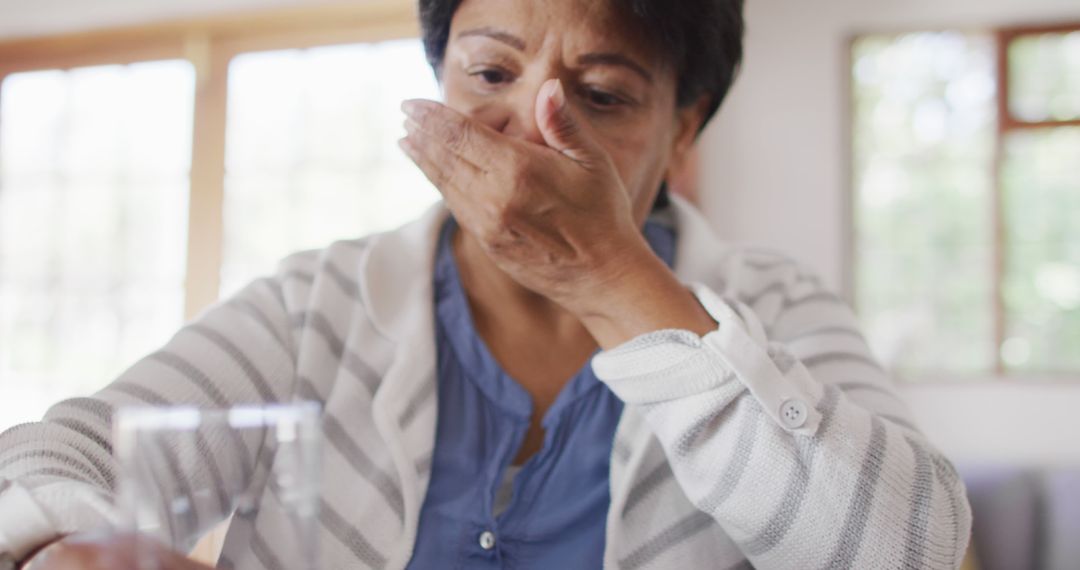 Senior Woman Feeling Nauseous at Home - Free Images, Stock Photos and Pictures on Pikwizard.com