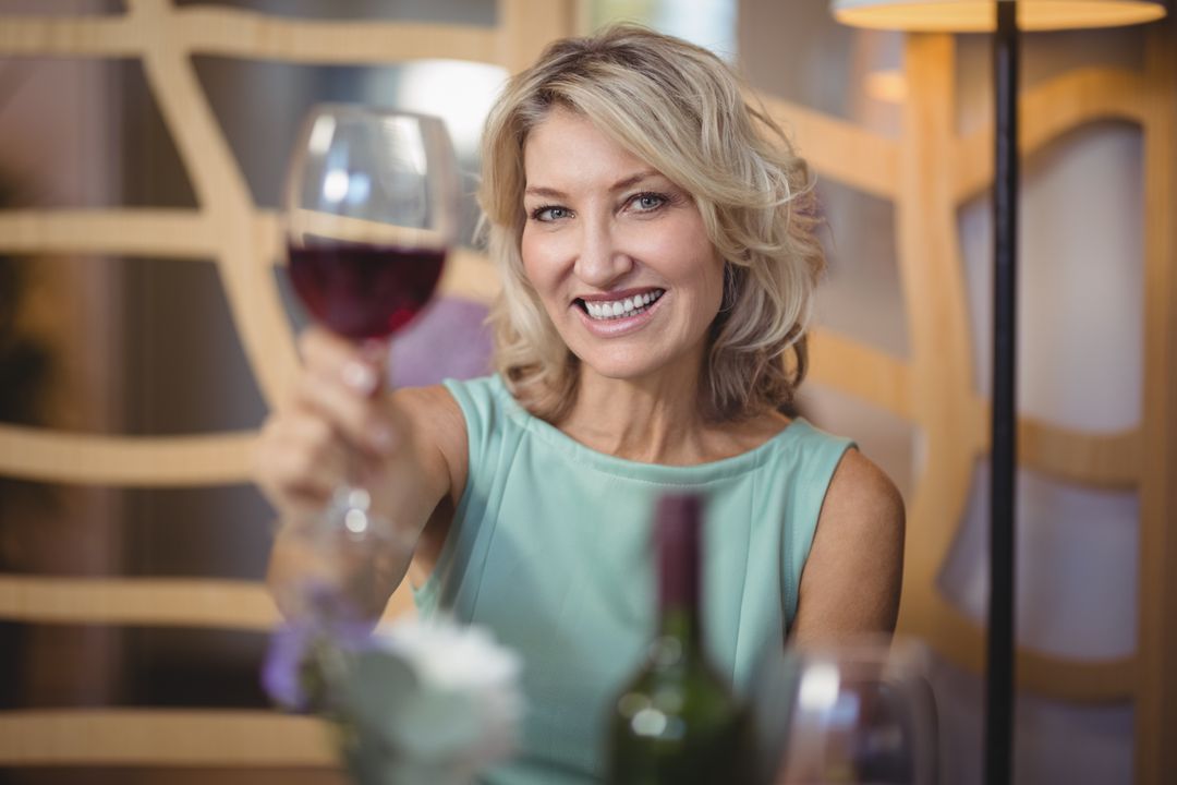 Portrait of mature woman holding a wine glass - Free Images, Stock Photos and Pictures on Pikwizard.com