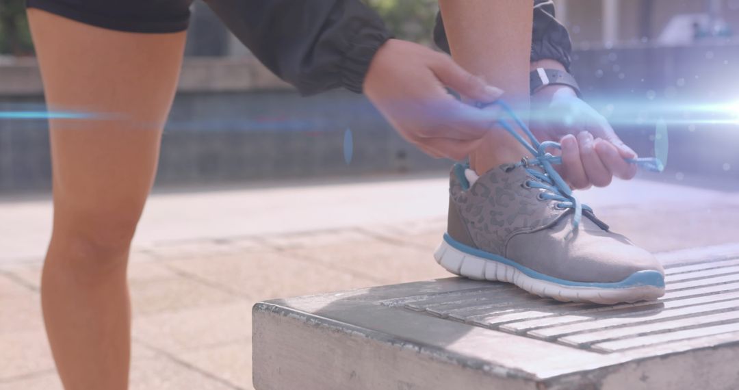 Fitness Enthusiast Tying Shoe Laces in Preparation for Outdoor Run