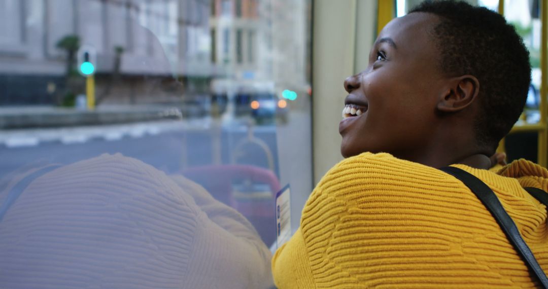 Smiling African American Woman Enjoying Views Through Window - Free Images, Stock Photos and Pictures on Pikwizard.com