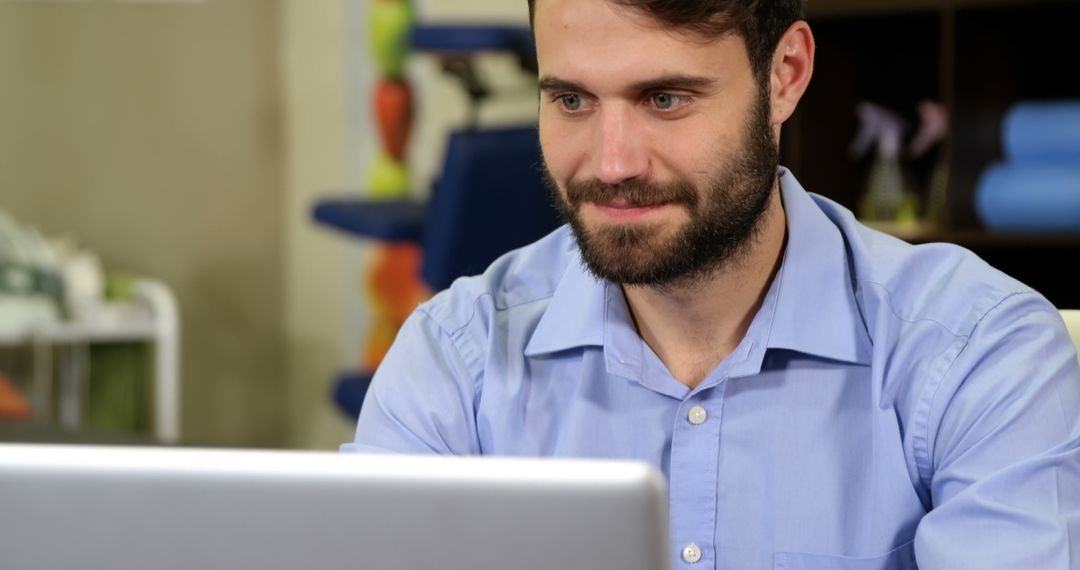 Bearded Man Working on Laptop in Modern Office - Free Images, Stock Photos and Pictures on Pikwizard.com