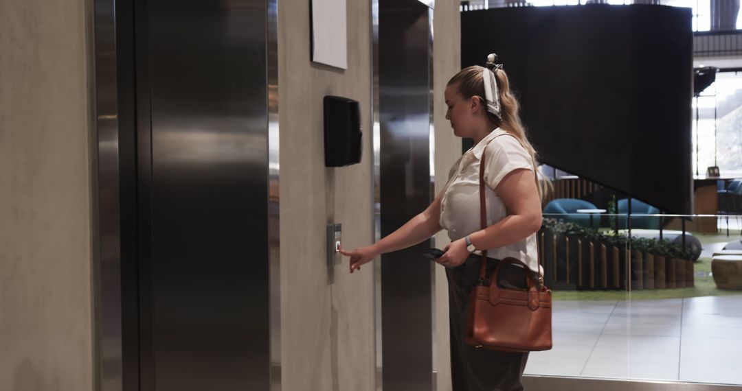 Businesswoman Waiting for Elevator in Modern Office Building Lobby