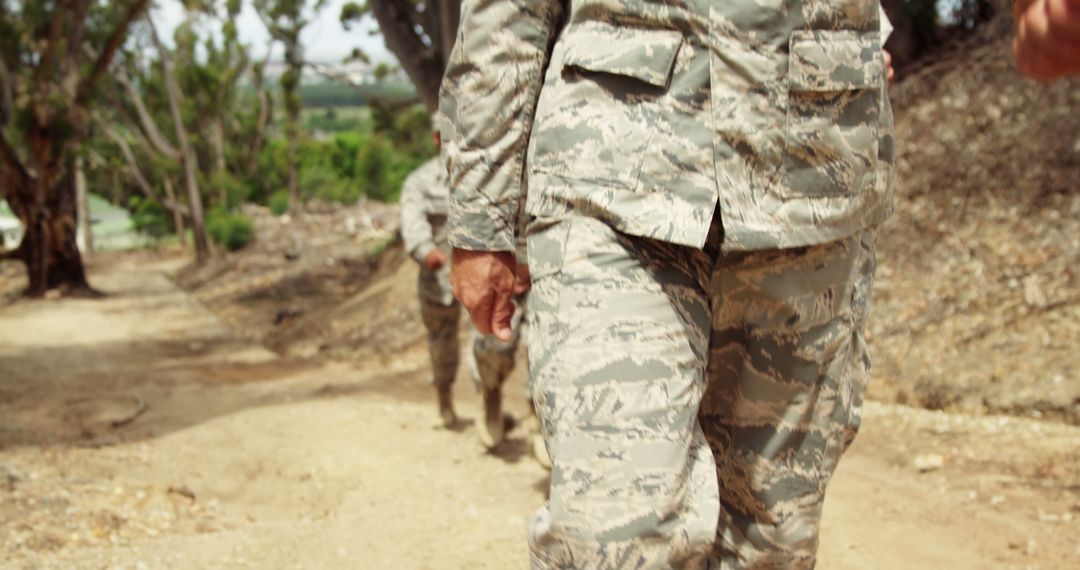 Soldiers in camouflage marching in formation outdoors - Free Images, Stock Photos and Pictures on Pikwizard.com