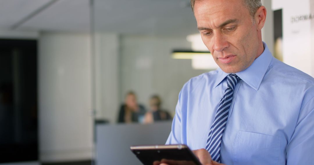 Focused Executive Engaging with Digital Tablet in Modern Office