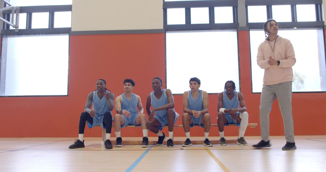 Diverse Basketball Team Staying Motivated on Sideline