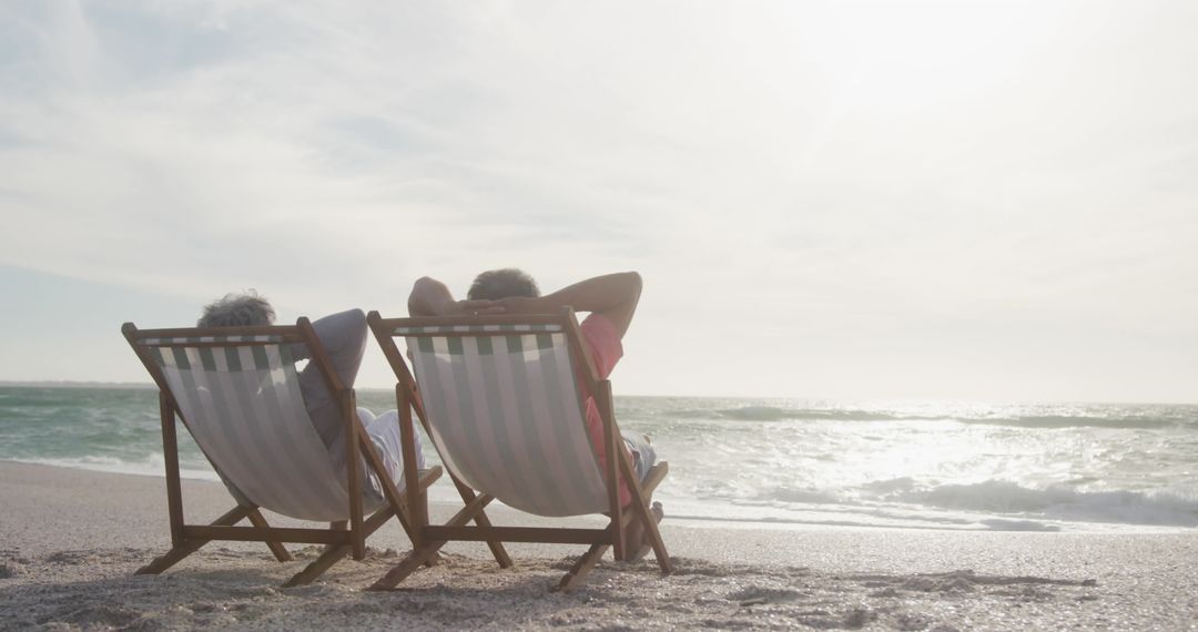 Senior Couple Relaxing on Beach Chairs by Ocean Seashore