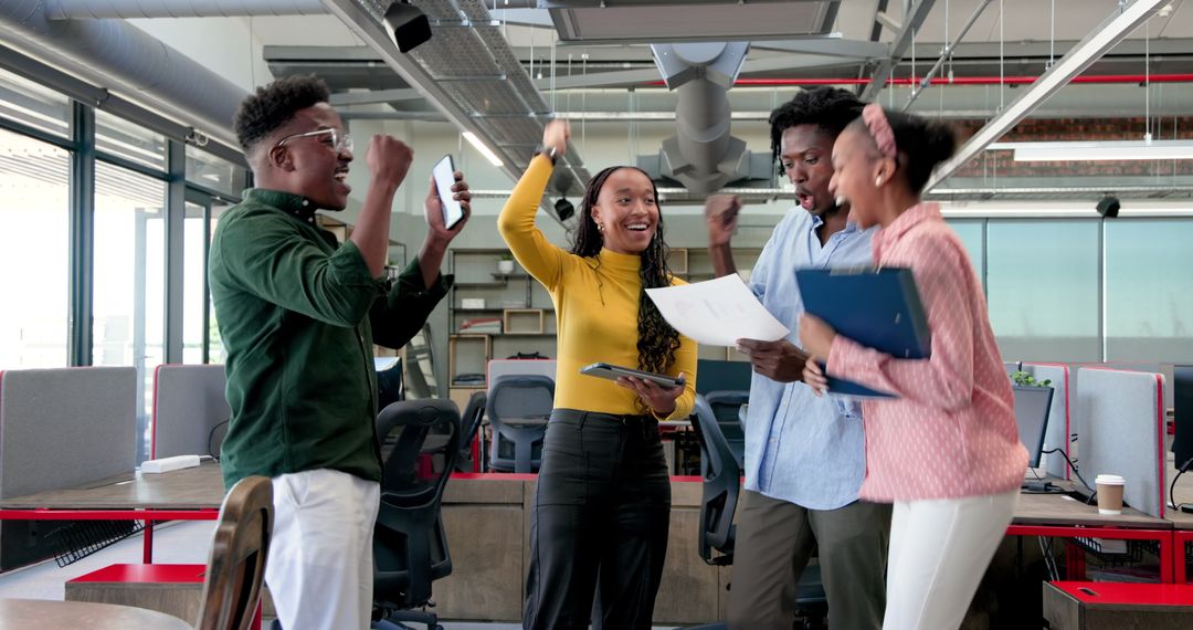 Joyful Diverse Team Celebrating Success in Modern Office Urban Setting