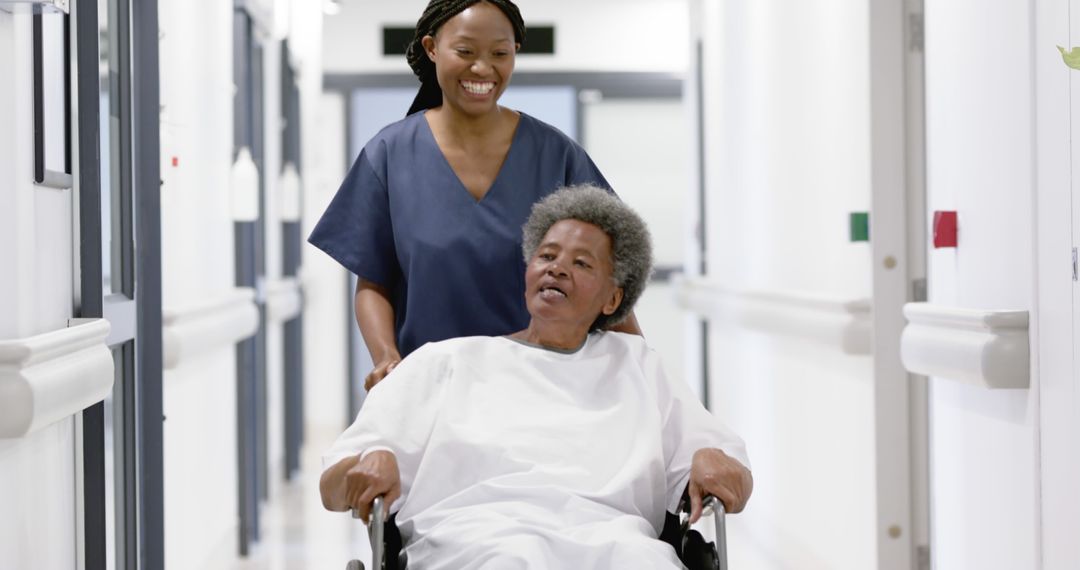 Nurse Pushing Elderly Patient in Wheelchair Down Hospital Corridor - Free Images, Stock Photos and Pictures on Pikwizard.com