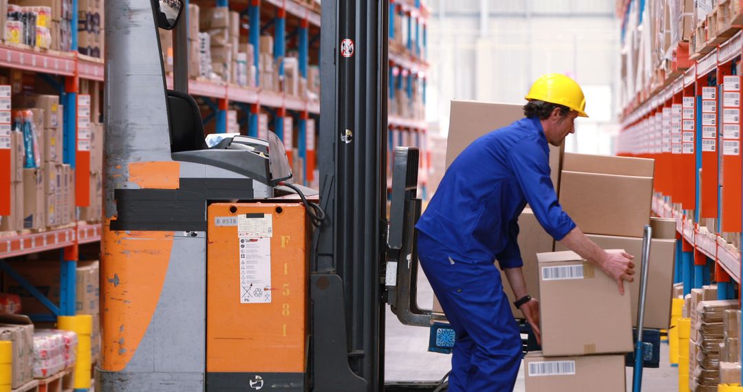 Warehouse Worker Loading Boxes on Forklift in Distribution Center - Free Images, Stock Photos and Pictures on Pikwizard.com