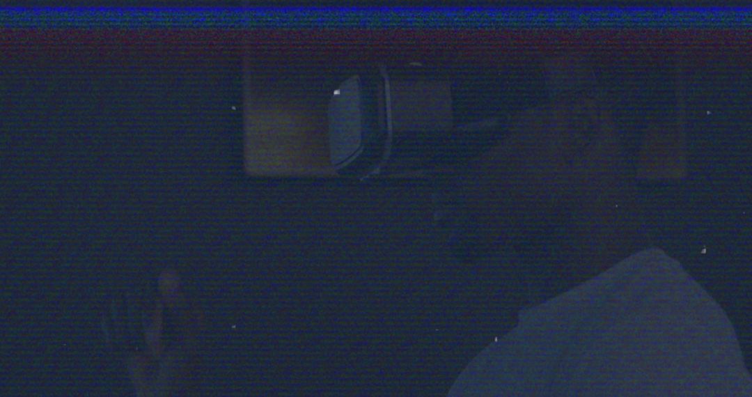 Man Engaged in Virtual Reality Experience in Dark Setting