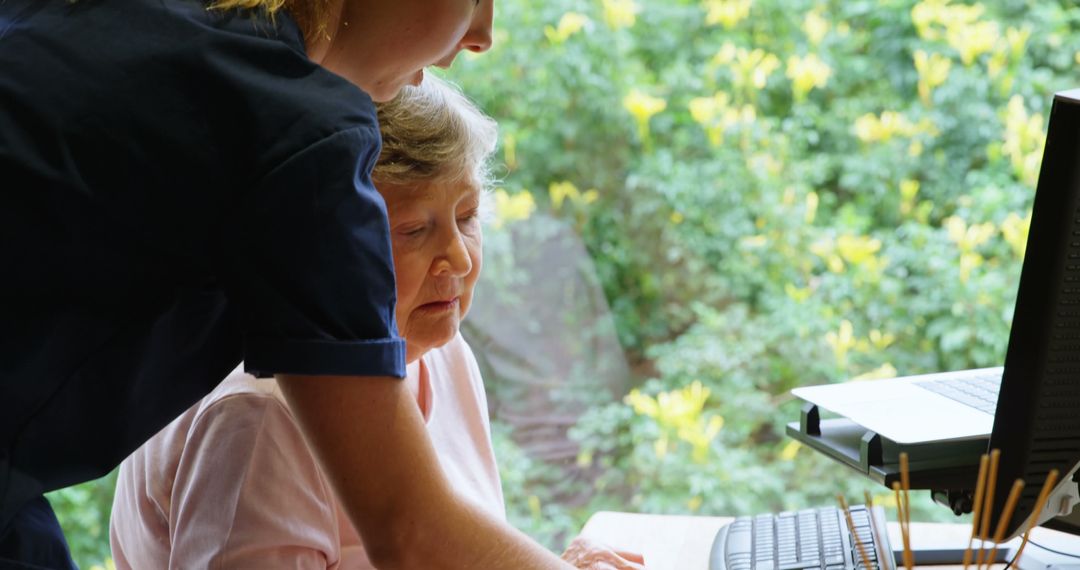 Nurse Assisting Elderly Woman Using Computer - Free Images, Stock Photos and Pictures on Pikwizard.com