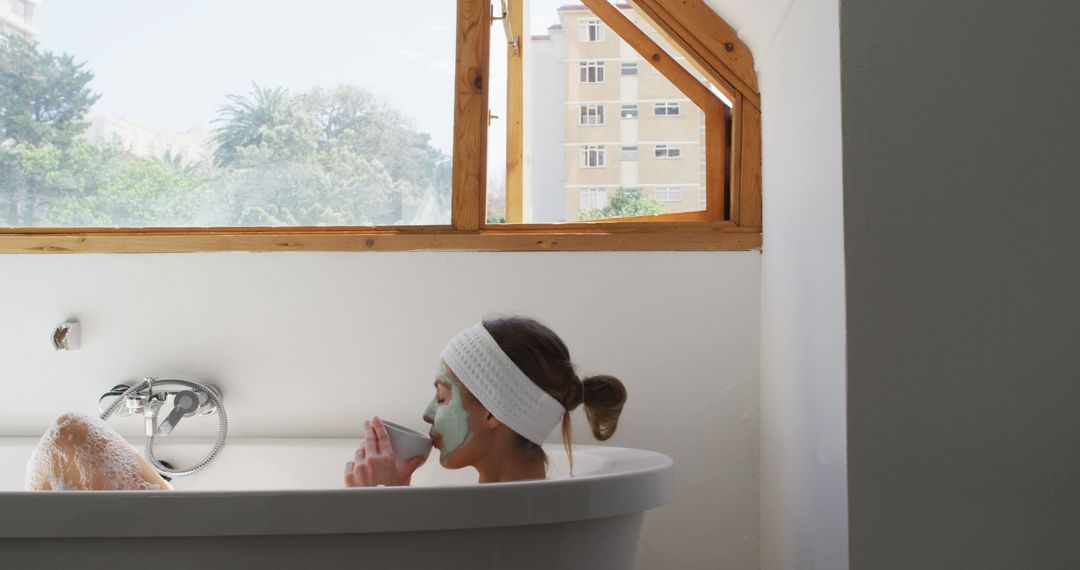 Woman Relaxing in Bathtub with Face Mask and Headband - Free Images, Stock Photos and Pictures on Pikwizard.com