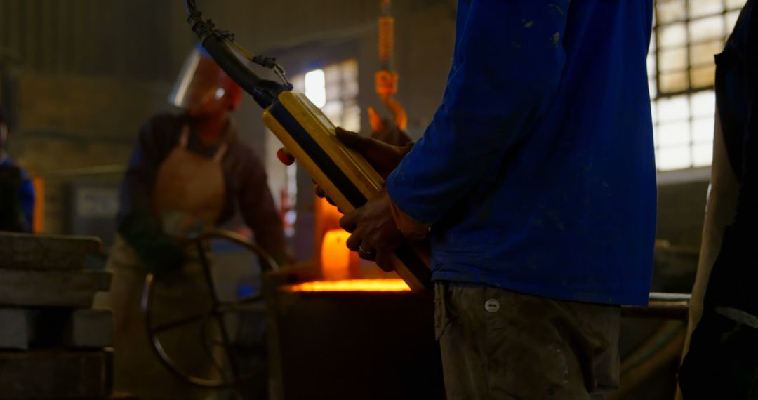 Steelworkers Pouring Molten Metal in Foundry - Free Images, Stock Photos and Pictures on Pikwizard.com