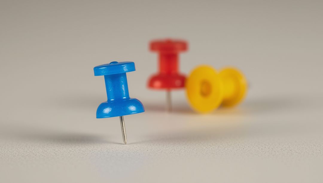 Colorful Push Pins on Desk Symbolizing Organization