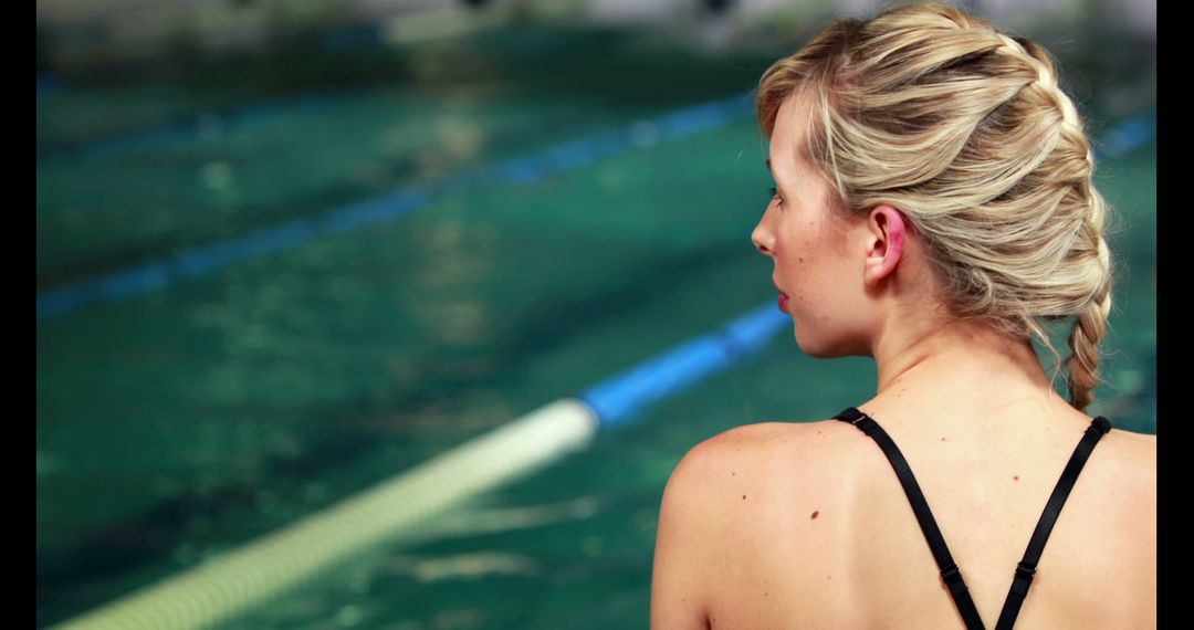 Female Swimmer Preparing by Poolside with Lanes in Background - Free Images, Stock Photos and Pictures on Pikwizard.com