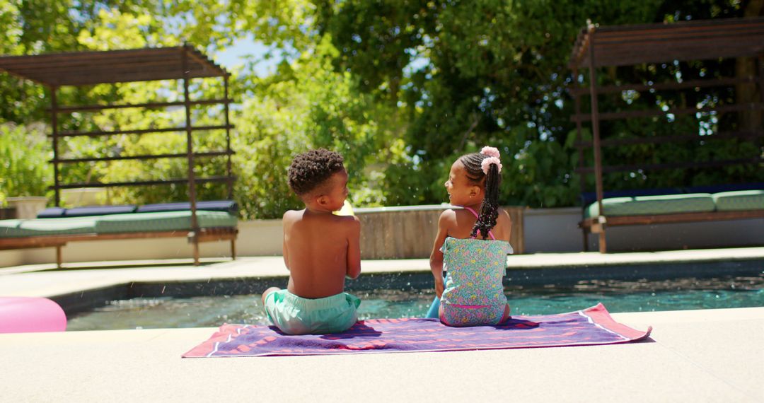 Children in swimsuits sitting by pool on sunny day - Free Images, Stock Photos and Pictures on Pikwizard.com