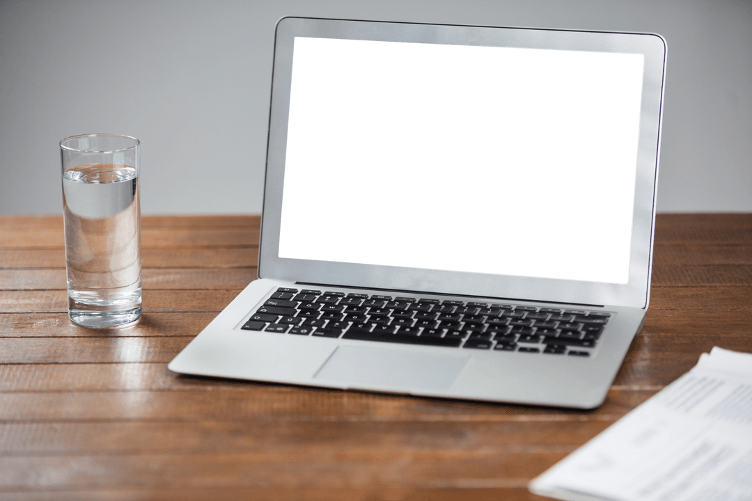 Transparent Laptop Screen on Wooden Table with Water Glass