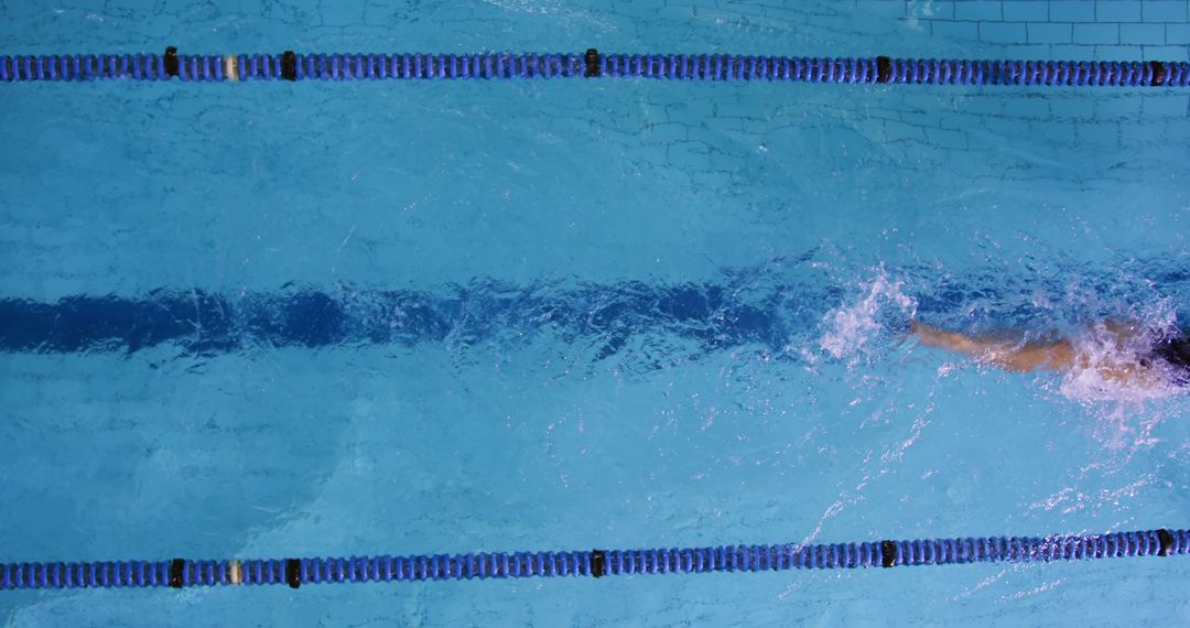 Competitive Swimmer in Pool Showing Powerful Stroke with Copy Space
