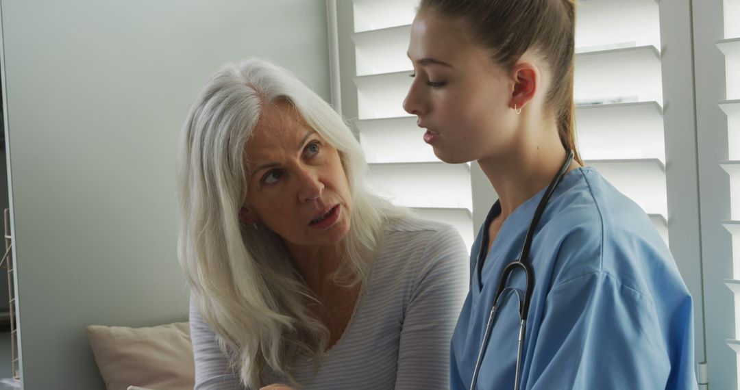 Nurse Communicating with Elderly Female Patient in Medical Clinic - Free Images, Stock Photos and Pictures on Pikwizard.com