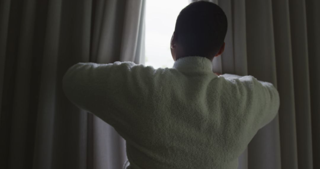Man Standing in Bathrobe Opening Curtains - Free Images, Stock Photos and Pictures on Pikwizard.com